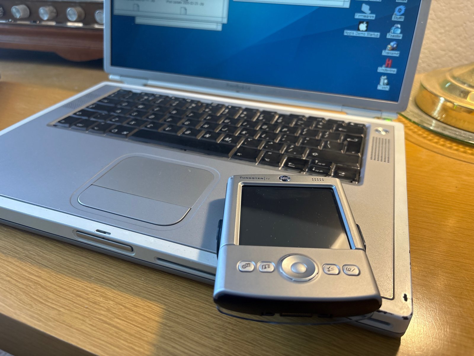 The titanium PowerBook with a Palm handheld.