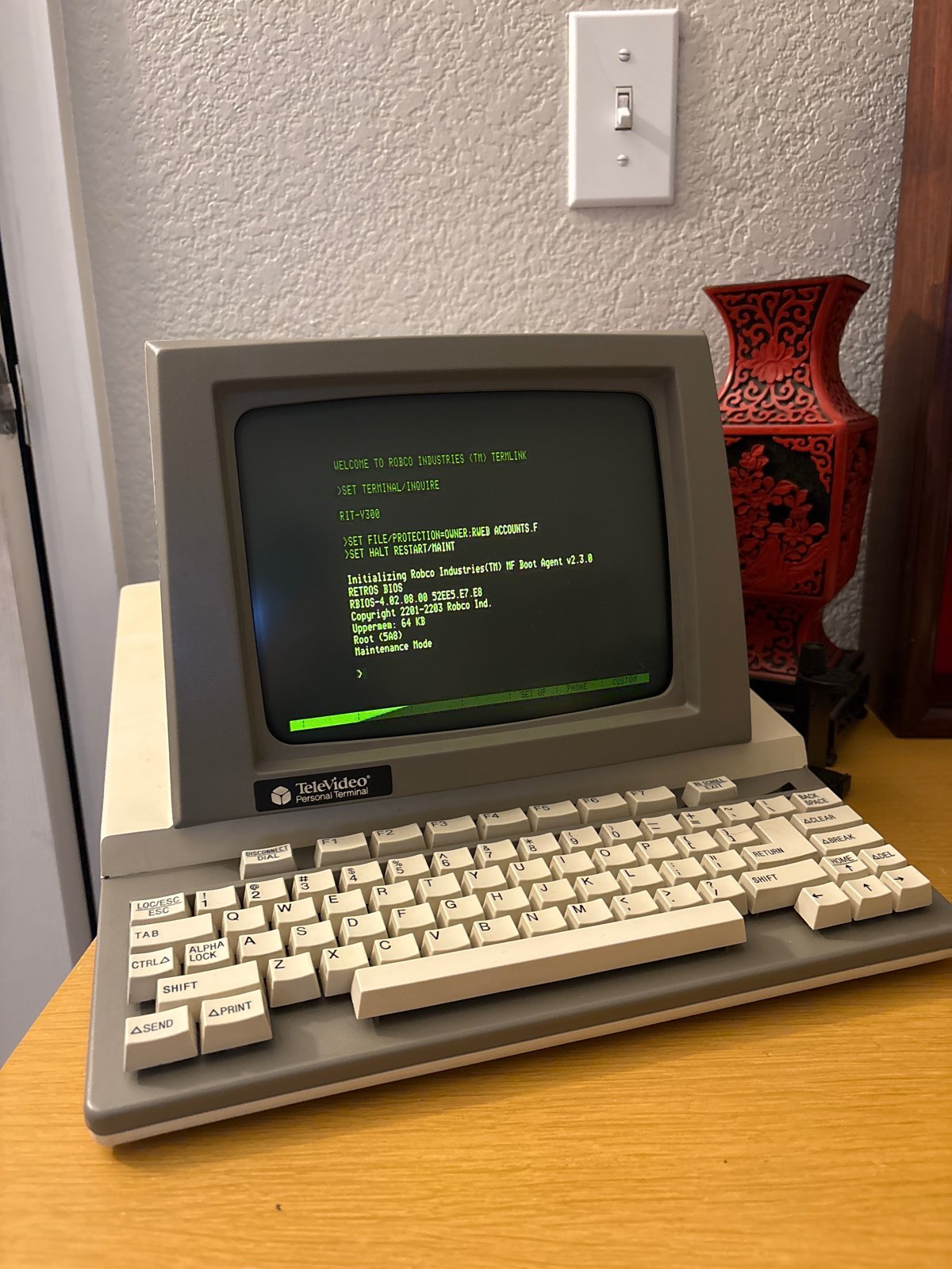 The Televideo PT displaying green text above its compact keyboard.
